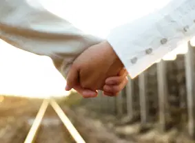 Two people holding hands as a symbol of togetherness